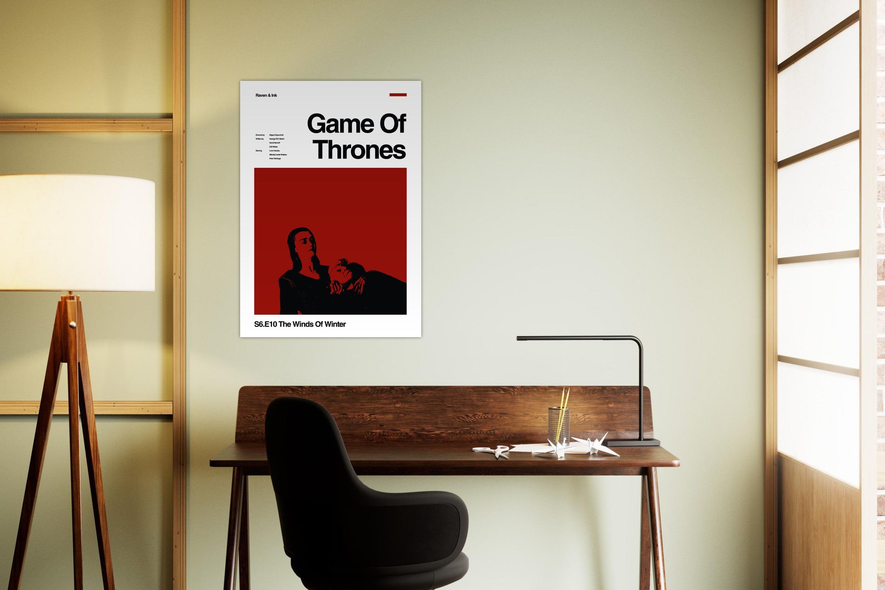 Game of Thrones poster on a wall above a desk in a room with a lamp and window blinds.