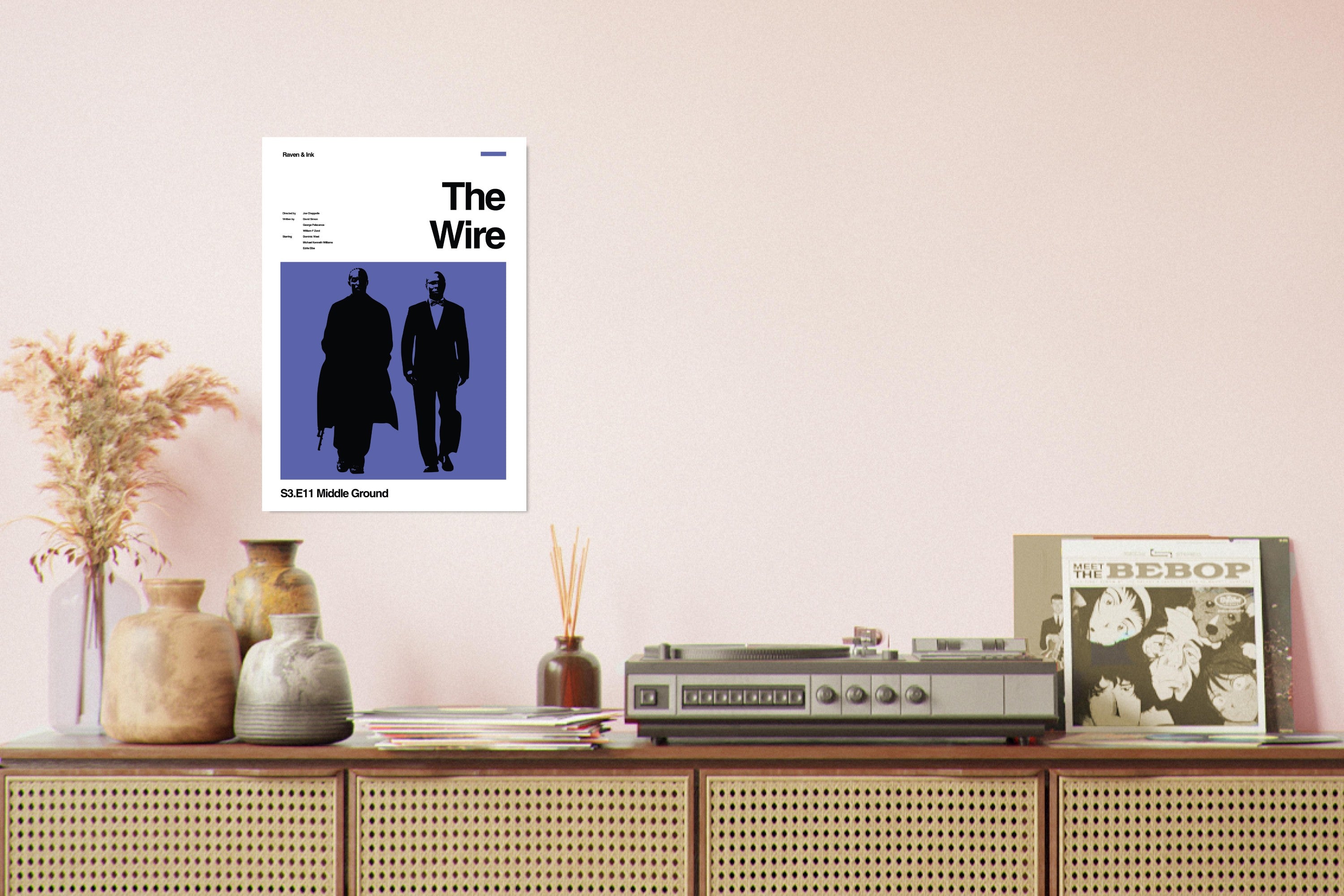 Poster of 'The Wire' on a wall above a wooden shelf with decorative items.